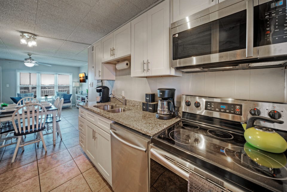 Bright, open layout connecting the kitchen, dining, and living areas—perfect for easy mornings, shared meals, and relaxed evenings after a day at the beach.