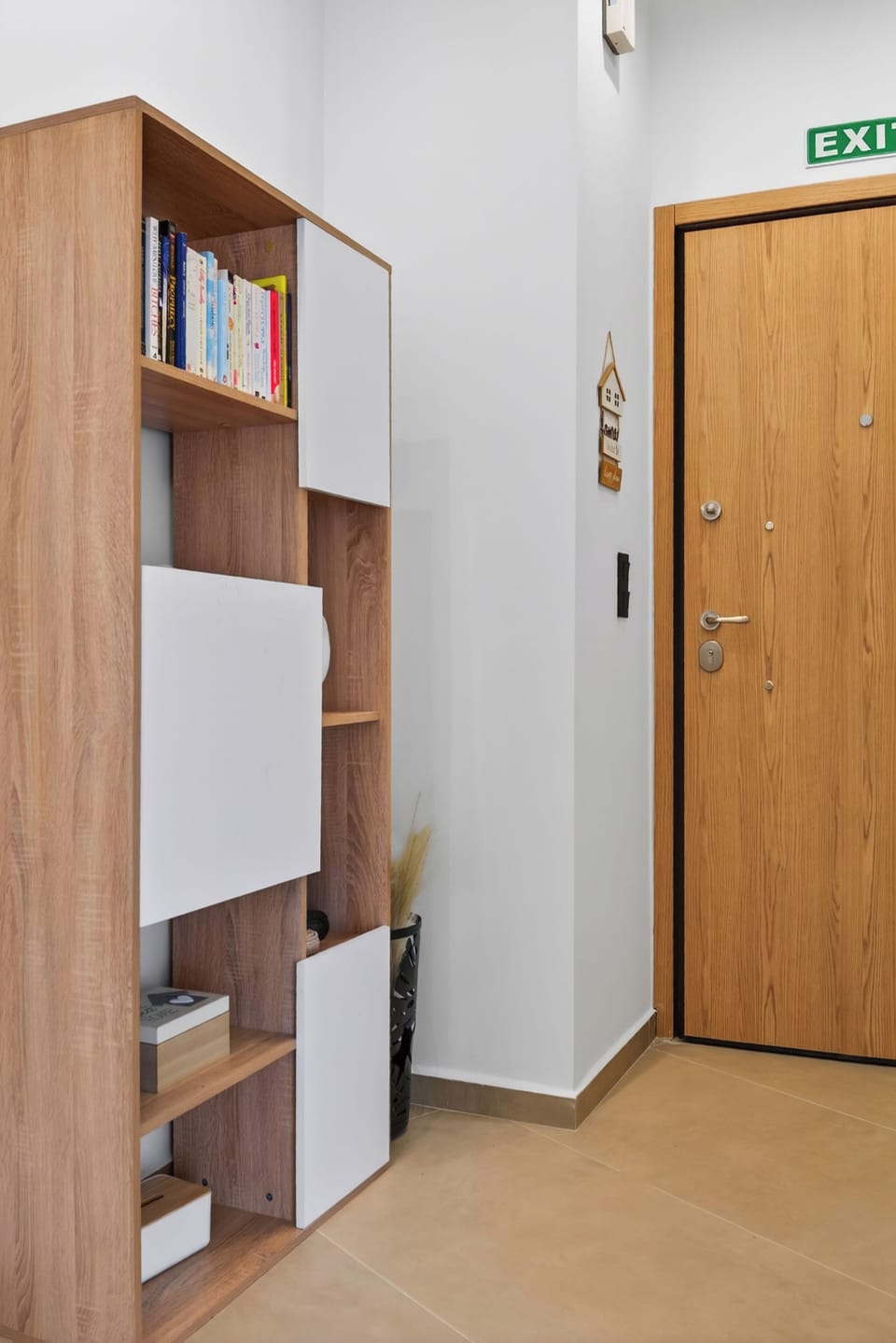 Bright stylish entryway with storage and bookcase, warm welcome home.
