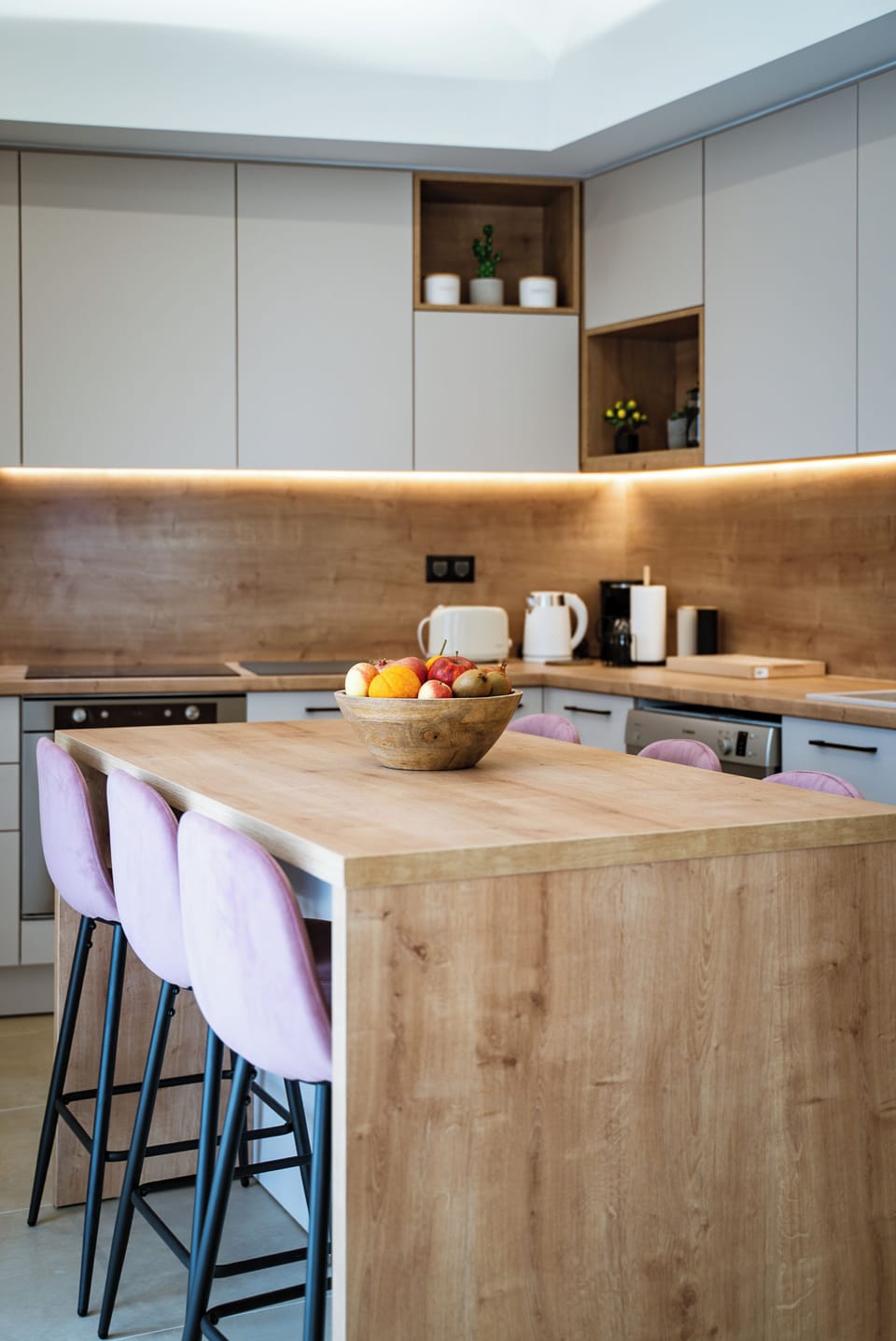 Modern kitchen with island seating and all essentials for home cooking.