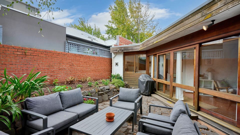 Private courtyard retreat with outdoor seating and BBQ area
