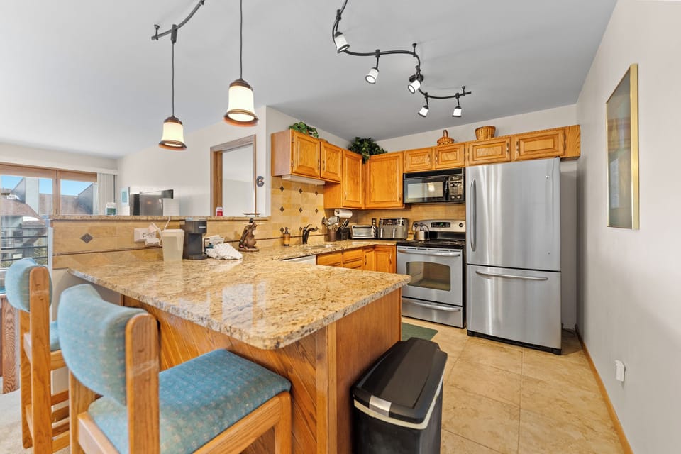 Your fully-equipped kitchen awaits with granite countertops, stainless steel appliances, and a breakfast bar where you can start your mornings right.
