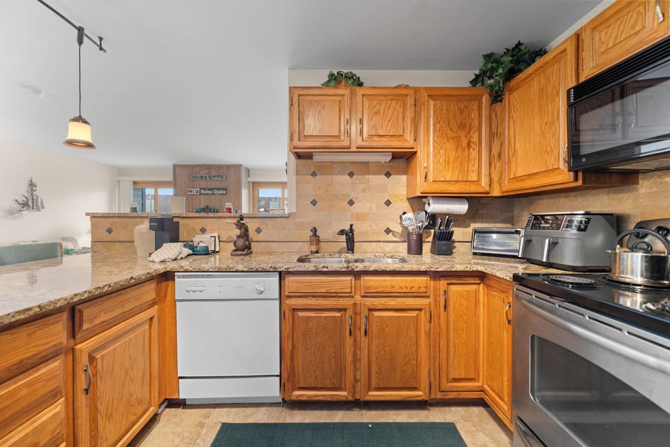 Your fully equipped kitchen features granite countertops, oak cabinets, and everything you need to create memorable meals together.