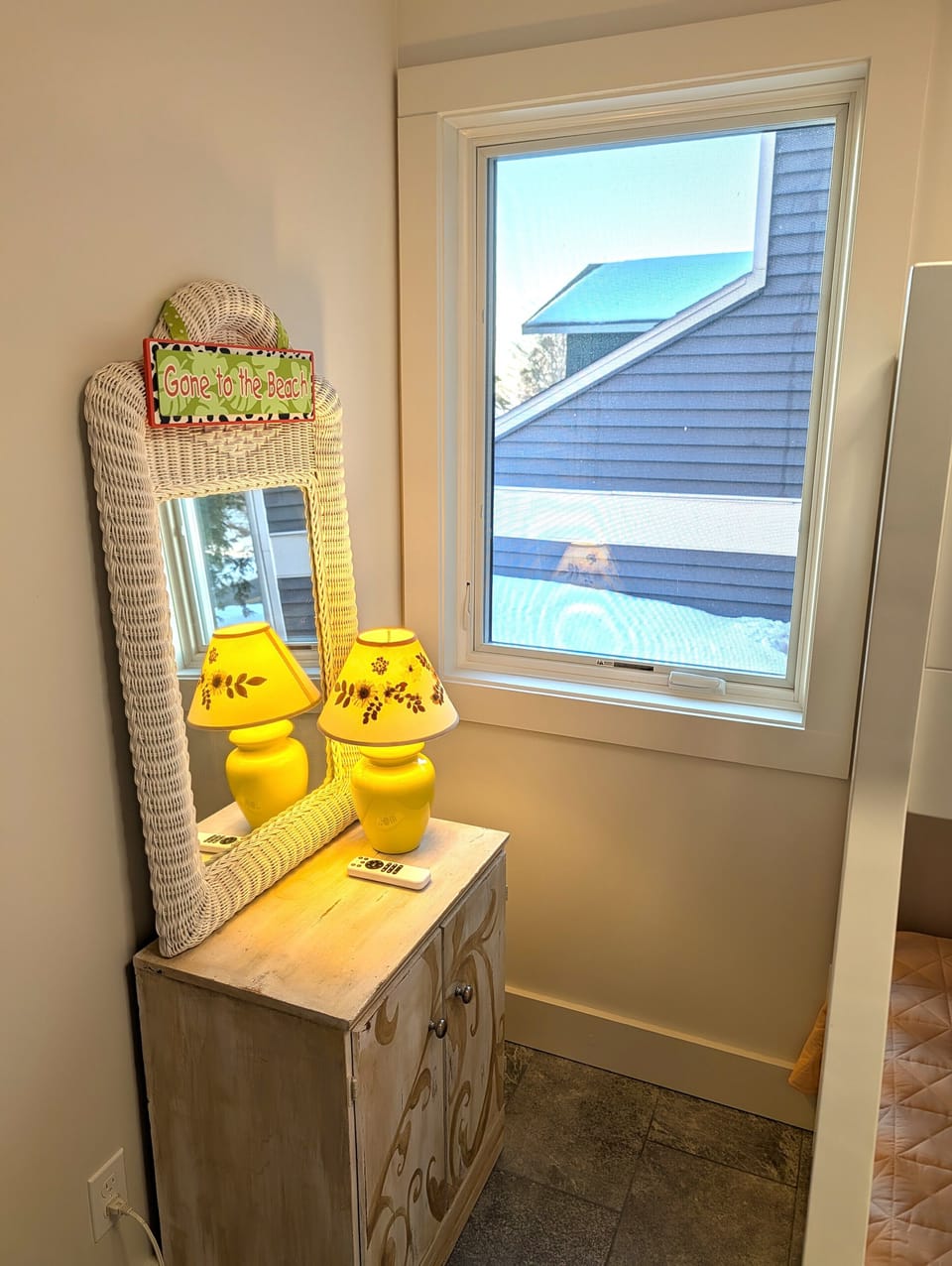 BEDROOM #2 (MAIN FLOOR):  Features a twin-on-full bunk bed, ceiling fan with safety guard, dresser, mirror, closet, and lamp.