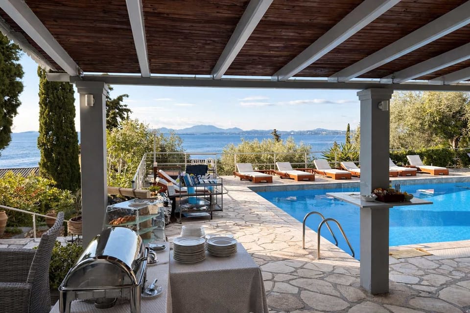 
Relax by the beautiful outdoor swimming pool overlooking the Ionian Sea, with a convenient pool bar serving refreshing drinks and light snacks. A perfect spot to unwind on a sun lounger while enjoying the stunning Barbati coastal views.