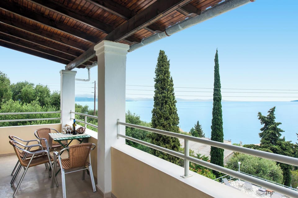 Enjoy peaceful mornings and relaxing evenings on the balcony overlooking lush greenery and the sparkling Ionian Sea.