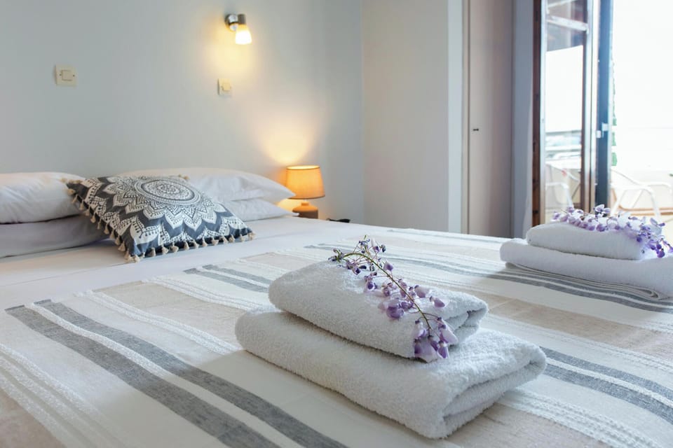 Inviting studio sleeping space with fresh linens, soft lighting, and comfortable bedding designed for restful nights during your stay in Barbati.