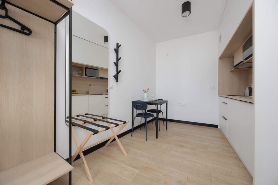 Open wardrobe and shelving system providing practical storage while maintaining the airy feel of the space.