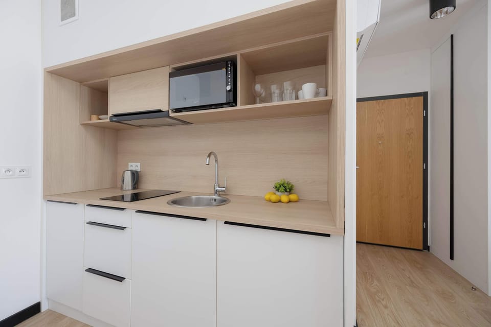 Well-organized kitchen space with overhead cabinets and integrated appliances.