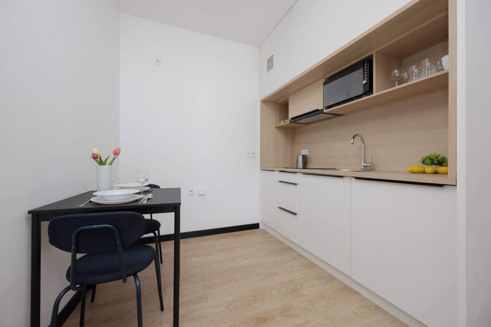 Practical kitchenette with countertop space and essential appliances for everyday cooking.