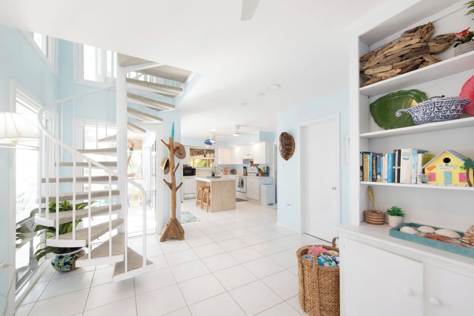 Spiral staircase to the home's 2 upper-level bedrooms. Don't worry, there's also a detached guest suite on the ground level for traveling seniors in your group.