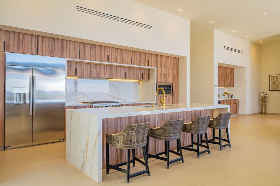 Your gourmet kitchen awaits with marble countertops, professional appliances, and a breakfast bar where you'll start each morning in style.
