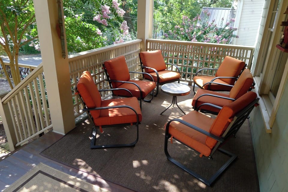 Large shaded front porch with plenty of seating.