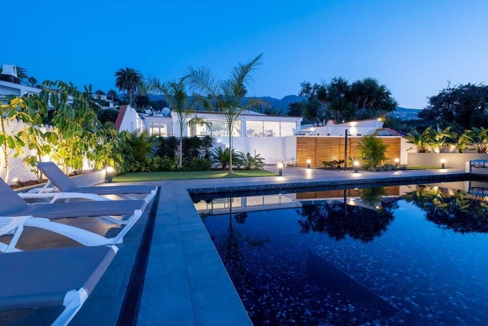 Evening by the pool – A peaceful retreat surrounded by nature and glowing ambient lights.