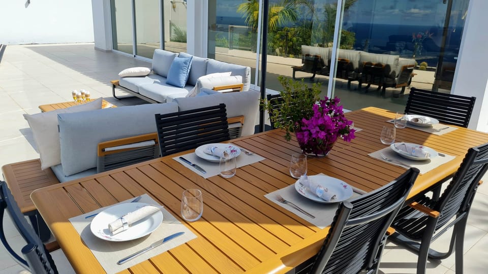 Outdoor dining area – Enjoy al fresco meals with stunning ocean views and cozy lounge seating.