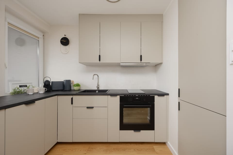 The sleek design of the kitchenette blending seamlessly with the living area.