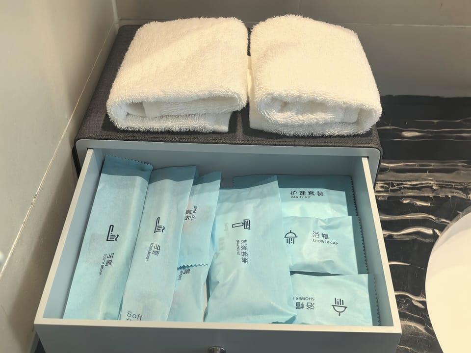 Shower, hair dryer, slippers, towels