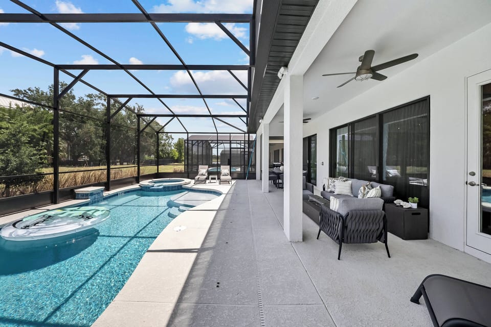 Step outside to a stunning outdoor area with a sparkling pool and relaxing spa, all complemented by modern furnishings. The spacious covered patio invites you to unwind, while large windows bring in plenty of natural light.