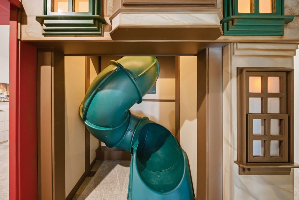 Explore a vibrant play area featuring a whimsical slide for endless fun. With charming architecture and playful colors, this inviting spot is perfect for families to enjoy quality time together in a delightful atmosphere.