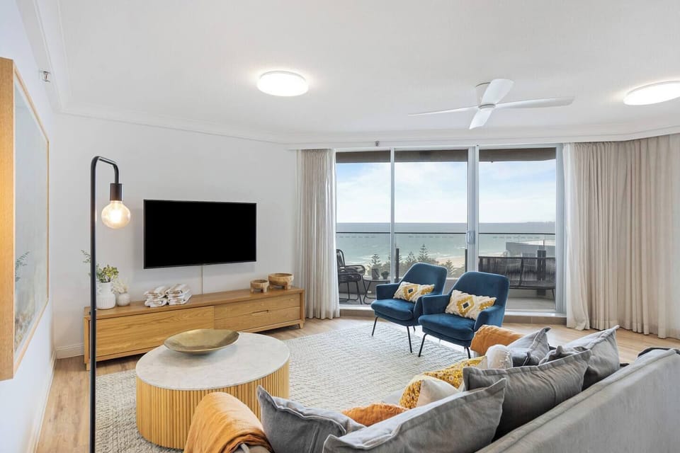 The cosy living area includes a sofa and armchairs to settle in with a movie after a day of sightseeing. 
