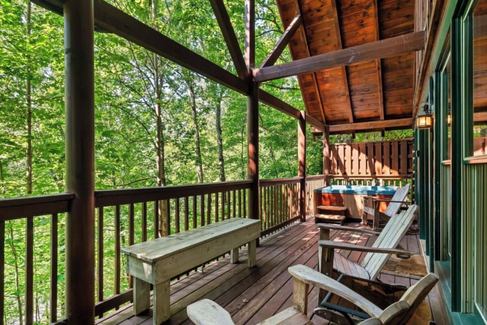 Unwind on your private deck surrounded by lush forest canopy, complete with hot tub and rustic seating for peaceful forest retreat moments.