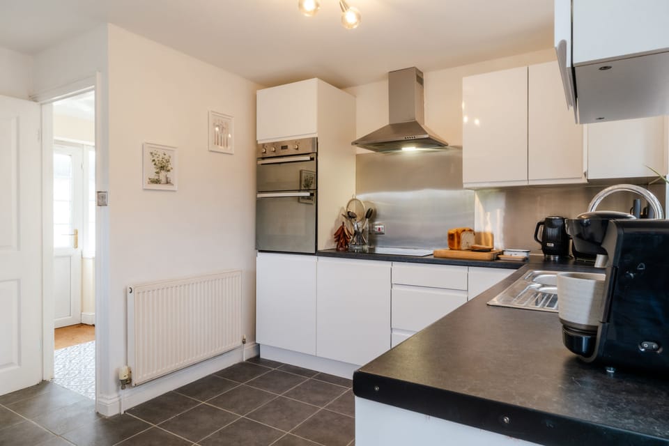 Modern kitchen with eye level electric double oven and Tassimo coffee machine