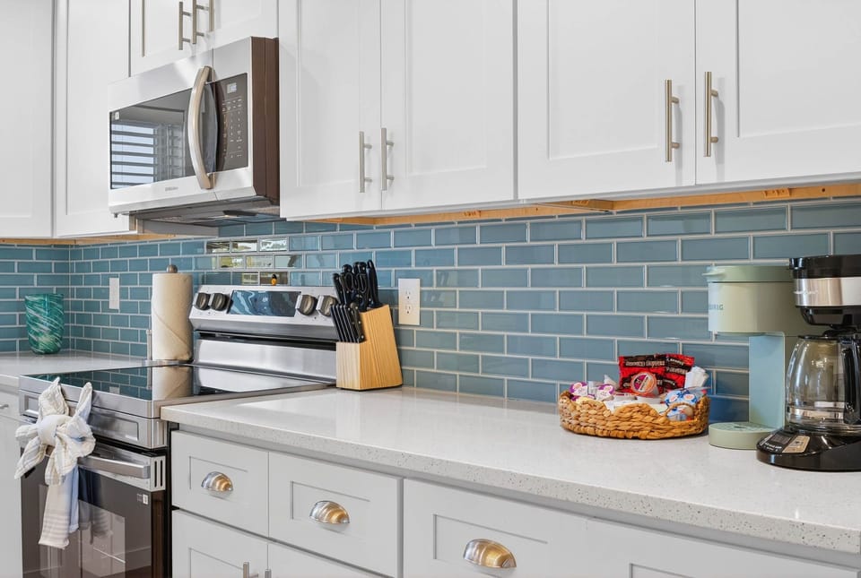 Fully equipped kitchen with a coffee station and sleek quartz counters!