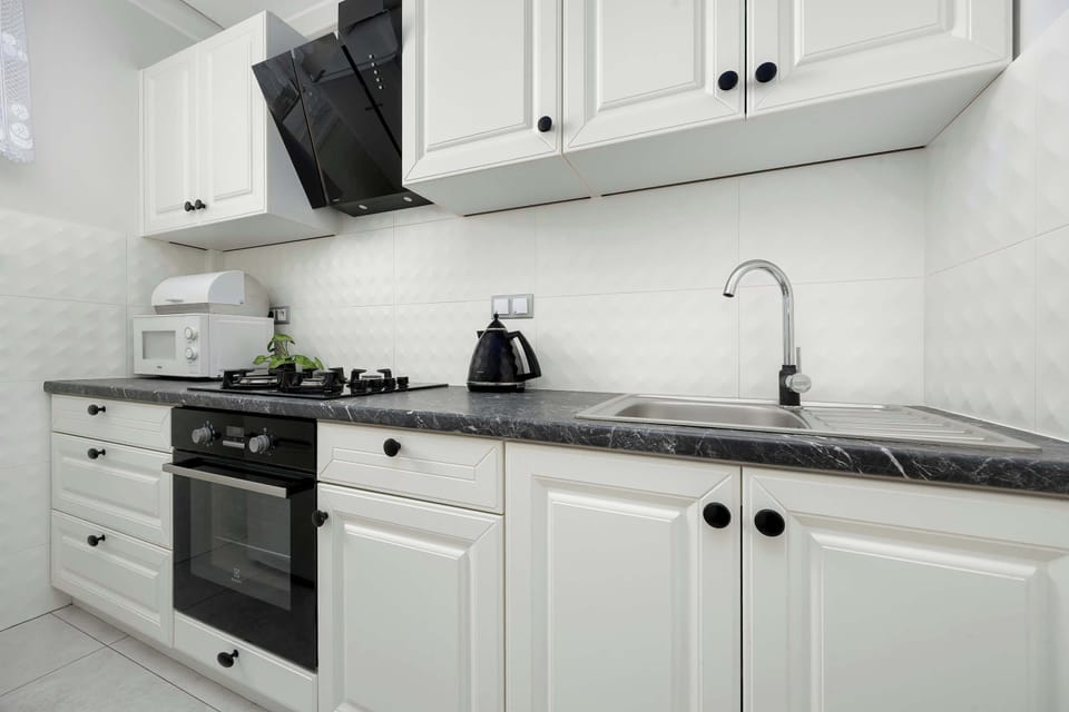 The kitchen's sleek design includes all necessary cookware and utensils.