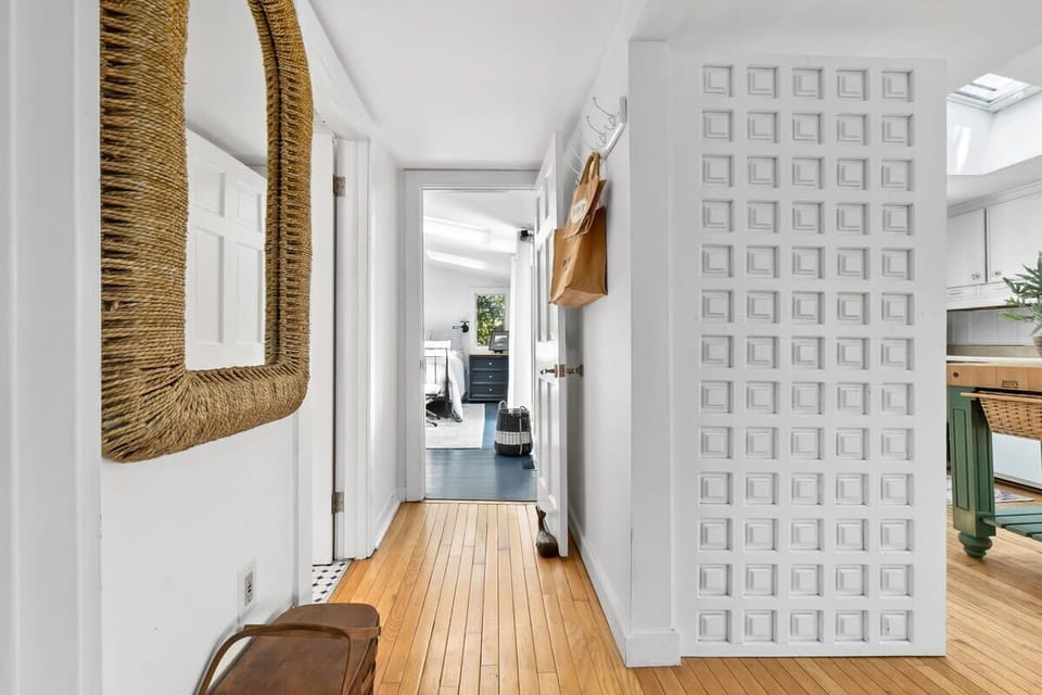 Off the kitchen is the main bathroom, and the secluded primary suite