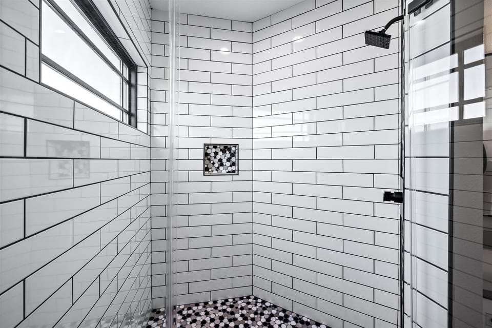 Shower Retreat: Modern tiled shower with stylish accents for a refreshing escape!