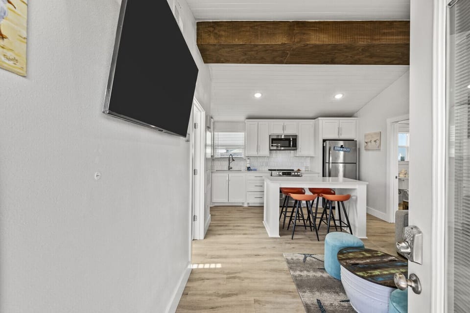 Step inside to a bright, open-concept space designed for easy coastal living