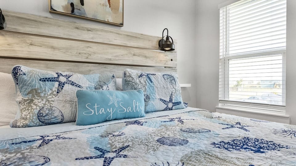 Wake up to sunshine streaming into this cozy coastal bedroom