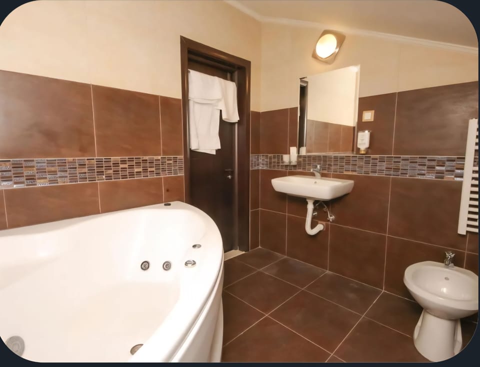 Bathrobes, slippers, bidet, towels