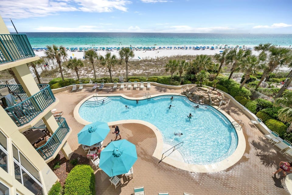 Large, Heated Seasonally, Resort Style Pool with plenty of lounge seating overlooking the Gulf of Mexico + a Hot Tub