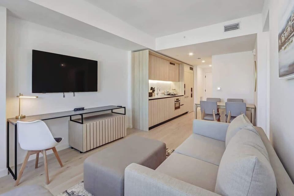 Bright living space with city views, Smart TV, and sofa.