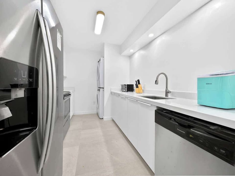 Fully stocked kitchen with modern appliances and essential cookware