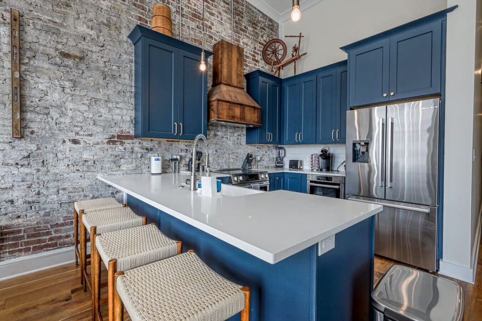 Gourmet Kitchen: Elevate your cooking with stylish blue cabinets and sleek modern appliances!
