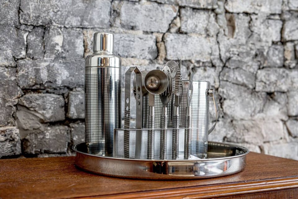Bar Cart: Shake up your evenings with gleaming cocktail tools against a chic brick backdrop!