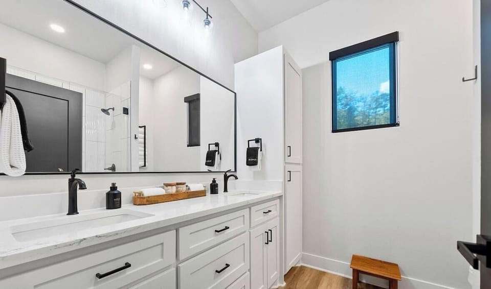 Bathroom one offers dual sinks, modern fixtures, and plenty of counter space to make getting ready feel effortless.