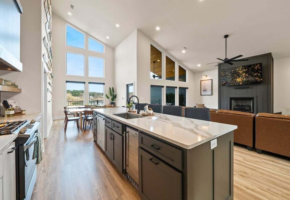 The bright and airy kitchen features high-end appliances, generous counter space, and an open design that keeps everyone connected.