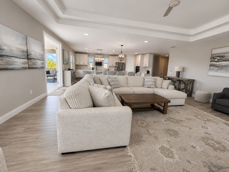 Sunlight, sea breezes, and space to gather—this open great room flows from sofa to table to the balcony beyond. Throw the doors wide, let the indoors and out become one, and watch the whole family drift happily between them all day long.