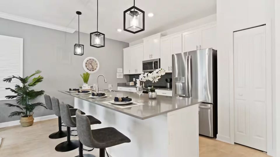 Barstools overlook an open kitchen