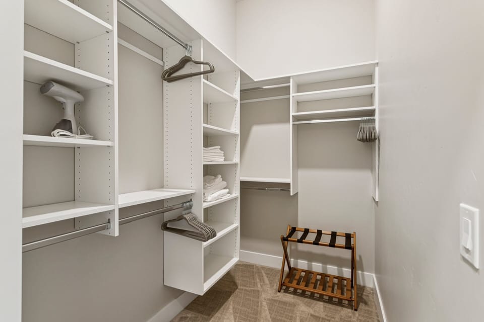 Primary bedroom walk-in closet