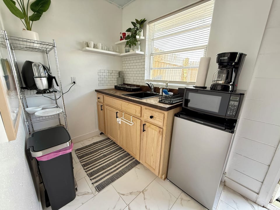 Kitchenette with mini fridge, microwave, coffee maker & sink