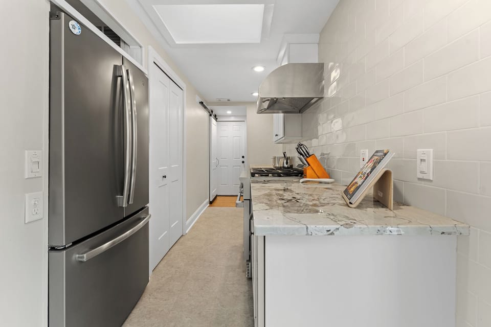 Chef's kitchen with propane range and stainless appliances