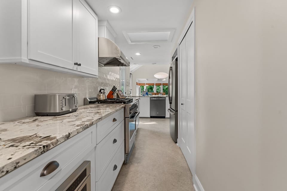 Chef's kitchen with propane range and stainless appliances