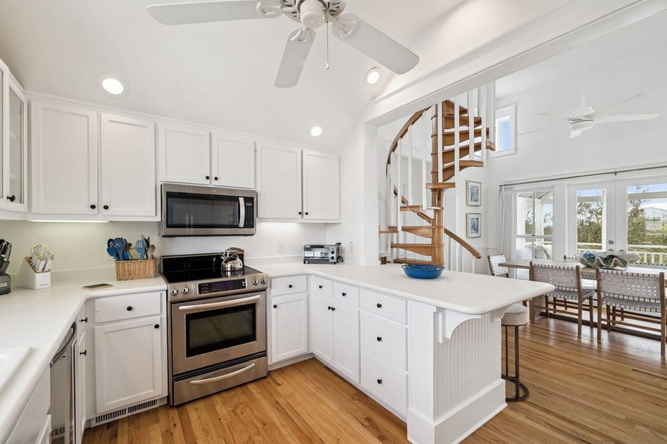 Chef's Kitchen with Natural Lighting, Signature Spiral Staircase, and Luxury Stainless Appliances