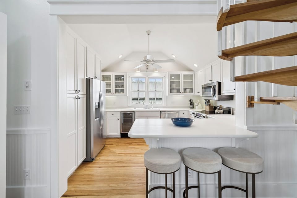 Chef's Kitchen with Natural Lighting, Signature Spiral Staircase, and Luxury Stainless Appliances