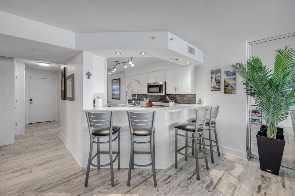 The spacious kitchen counter with barstool seating is perfect for morning coffee, quick bites, or gathering after a sun-soaked day on Ormond Beach
