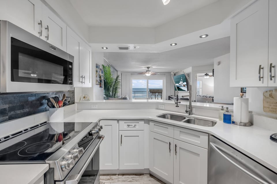 This updated kitchen shines with top-of-the-line appliances and sleek quartz countertops