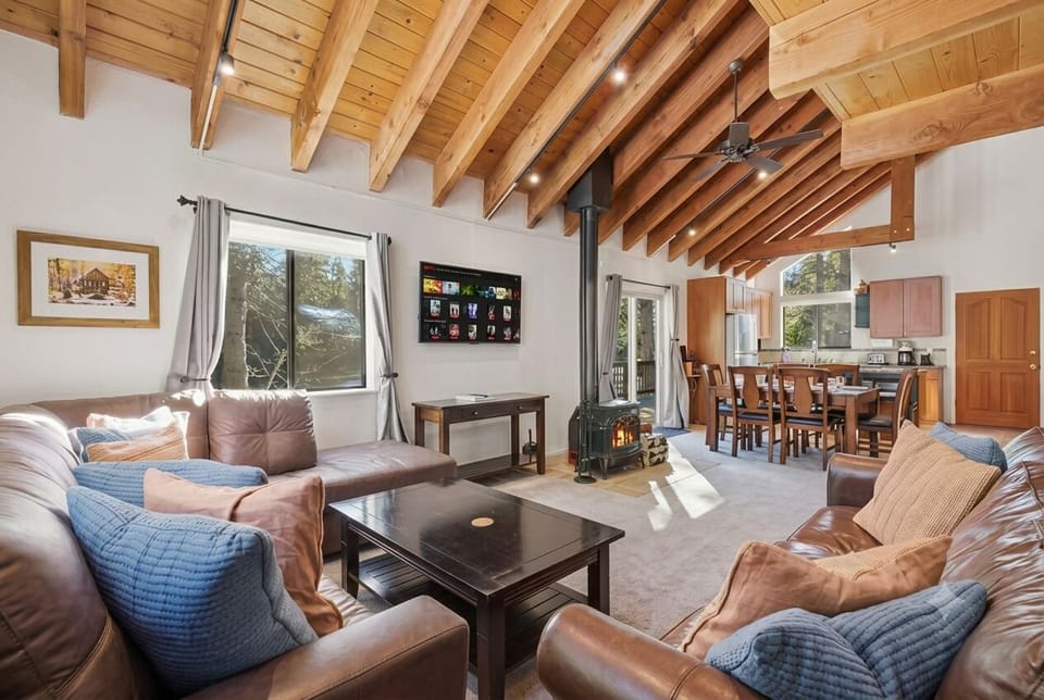 Cozy corner angle showing the TV, bright windows, and sliding door, with the din